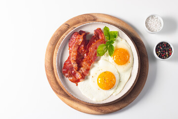 Delicious traditional English breakfast with fried eggs and bacon