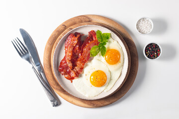 Delicious traditional English breakfast with fried eggs and bacon