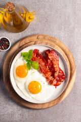 Delicious traditional English breakfast with fried eggs and bacon