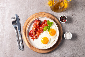Delicious traditional English breakfast with fried eggs and bacon