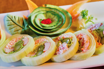 sushi platter with fresh seafood, cucumber, wasabi, and soy sauce