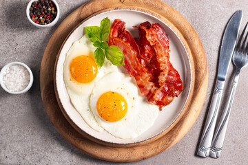 Delicious traditional English breakfast with fried eggs and bacon