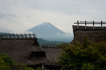 View of roof of a few old Japanese style houses with background Mt. Fuji at during summer in Japan.