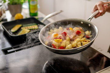 Steamy Skillet Cooking Fresh Vegetables and Potatoes on a Modern Kitchen Stovetop