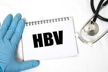 HBV in notebook isolated on bright white background. doctor's hand and stethoscope.