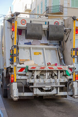 Rear View of Garbage Utility Truck at City Street in France