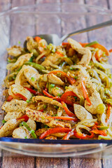 oven baked naked fajitas with chicken, bell pepper, onions, and jalapenos, with a serving spoon