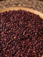 Fototapeta premium Organic uncooked seeds dark red brown lentils.