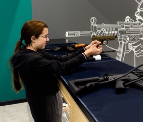 Girl is training shooting with an air rifle