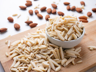 Almond and White Almond Stick set on wooden board and white background.
