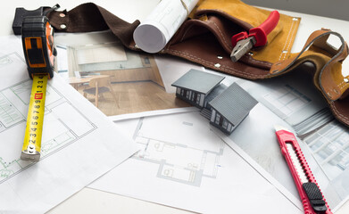 Model of a family house on a blueprint.