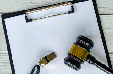 Top view of blank paper with lawyers gavel and whistle with customizable space for text