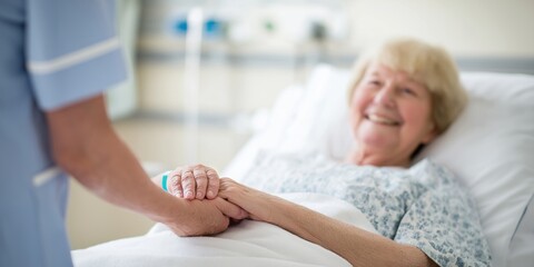 Fototapeta premium Caring nurse smiles while holding the hand of a senior patient in a hospital setting.