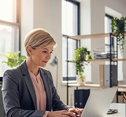 Professional Woman Working on Laptop in Office