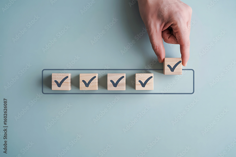 Poster hand placing a checkmark on a wooden block in a checklist