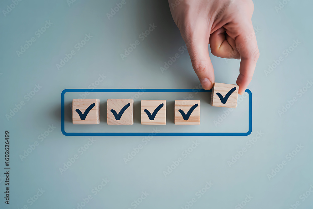Poster hand placing a wooden block with a checkmark to complete a list