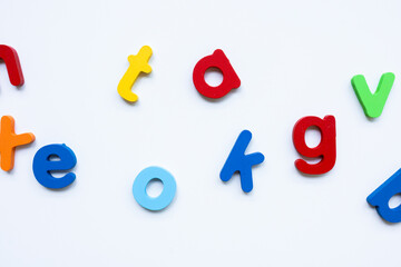 Colorful plastic alphabet letters on white background for educational activities