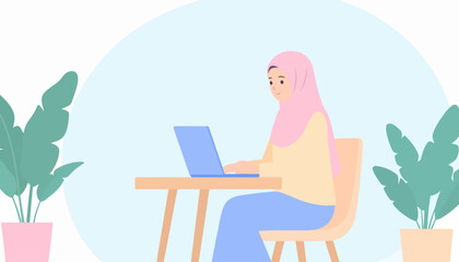 Fototapeta premium Focused Muslim woman in a pink hijab and pastel clothes, sitting at a desk and working on a blue laptop.