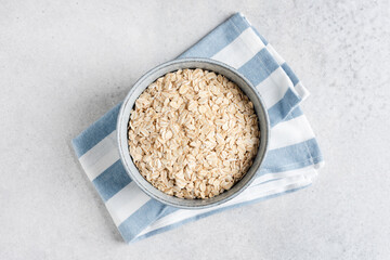 Rolled oats in bowl. Table top view