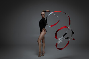 Rhythmic gymnastics in studio soft light.