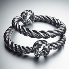 Two identical flexible bangles in blackened palladium each conta
