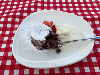 French dessert chocolate fondant with strawberries and ice cream.
