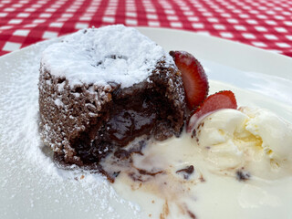 French dessert chocolate fondant with strawberries and ice cream.