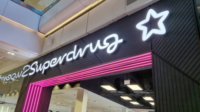 London UK - 07.01.2025 Superdrug store entrance in shopping mall with illuminated logo and pink neon lights, known for selling cosmetics, toiletries, health and beauty products