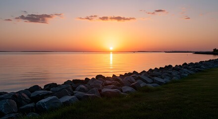 Sunset over calm water with rocks
