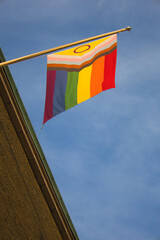Pride flag hanging from wall in Gothenburg, Sweden, in the sundown