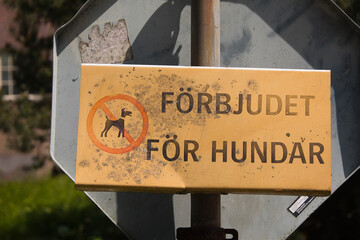 Old and worn dogs prohibited sign in Swedish