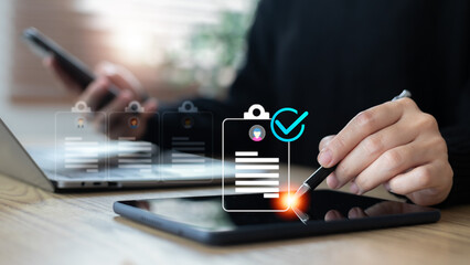 Digital recruitment concept showing a hand using a stylus on a tablet to select a resume with a...