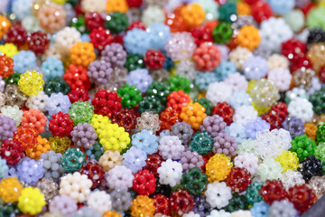 Colorful assortment of vibrant beads in various shapes and sizes creating a visually appealing...