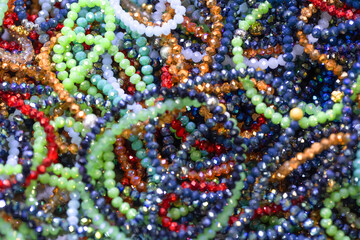 Colorful assortment of beads in various shapes and sizes creating a vibrant visual texture