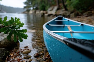 Obraz premium A beautiful canoe resting by serene waters, surrounded by lush nature, illustrating tranquility and the peaceful escape offered by outdoor adventures in a natural setting.