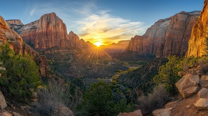 A panoramic shot of a mountain range at sunrise, with the first rays of light illuminating the rocky cliffs.