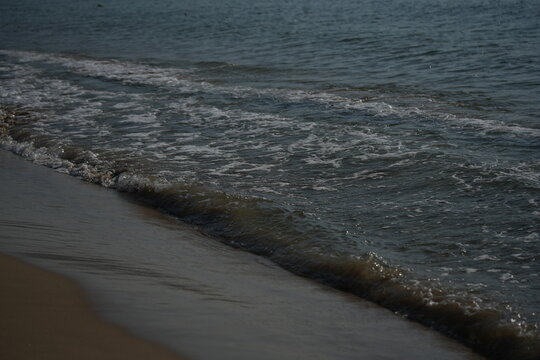 sea shore with wave breaking on the beach gentle sea wave breaking on a sandy shoreline. peaceful coastal scene with soft water movement and natural textures. perfect for themes of relaxation
