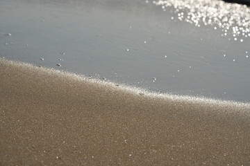 Calm sea waves rolling onto the shore under soft morning light. Gentle ocean surface with small ripples and a peaceful horizon Serene coastal scene perfect for themes of nature, relaxation, and summer © Анна Климчук