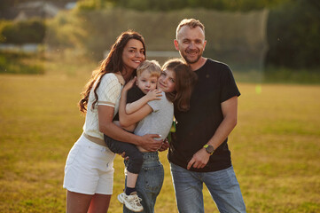 Photo of happy family with husband, wife and two kids