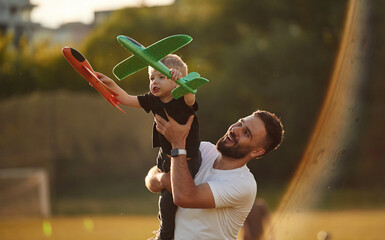 Happy father with son on the field