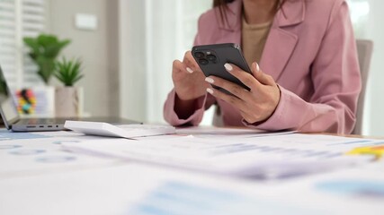 Businesswoman analyzing financial data using calculator, holding documents surrounded by charts, graphs and laptop, showing professionalism, business planning. - Powered by Adobe