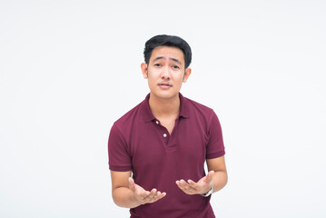 A frustrated young Asian man using expressive hand gestures while explaining and defending himself. Isolated on a white background.