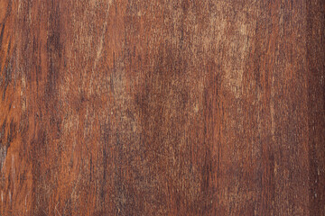 Close-up of a textured wooden surface with rich brown tones and natural grain patterns. Ideal for...