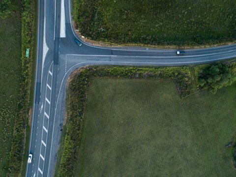 Overhead aerial top down view of t intersection with cars turning off main road &ndash; Golden Highway