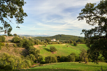 Fototapeta premium Agricultural landscape with meadows on the hills in Tuscany