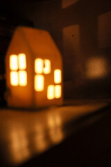 The light from the decorative home lighten the way of flying bird on the photo on shelf