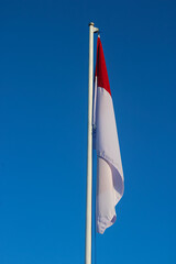 Majestic Indonesian Flag Against Clear Blue Sky