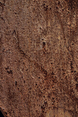 Close-up of textured wood surface with natural patterns and grain. Rich brown tones and visible...