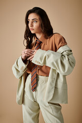 Stylish young woman showcases modern fashion in sophisticated studio setting