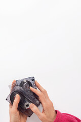 Female hands holding vintage audio cassettes with old watch on white background. Hand holding an audio cassette with a watch visible, evoking retro nostalgia and a journey back to the past